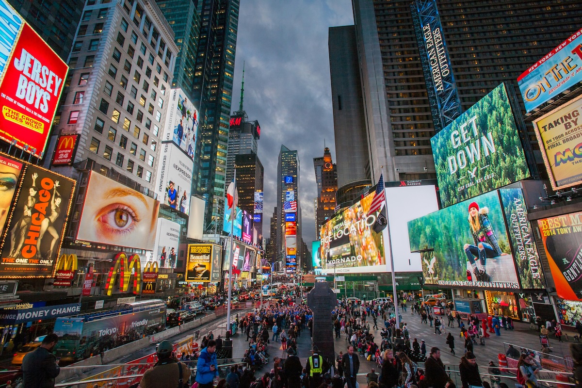 Times Square in New York City lit up with billboards at dusk